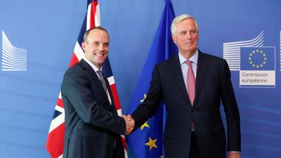 Britain's chief Brexit negotiator Dominic Raab, left, is welcomed by his EU counterpart Michel Barnier ahead of a meeting at the European Commission in Brussels. Stephanie Lecocq
