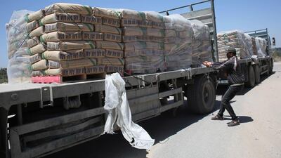 A Palestinian worker adjusting bags of cement loaded onto a truck after it entered the southern Gaza Strip from Israel through the Kerem Shalom crossing in Rafah on April 29, 2015. Israel said on Monday it had stopped private imports of cement to the Hamas-run Palestinian enclave. Said Khatib/AFP Photo