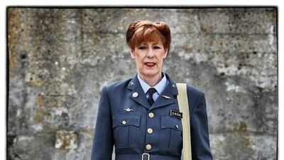 Elaine Mumby, from the United Kingdom, wears a replica uniform of a Section Officer of the British Royal Air force.