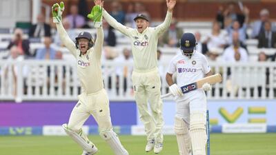 Jos Buttler and Joe Root celebrate after the dismissal of Ajinkya Rahane.