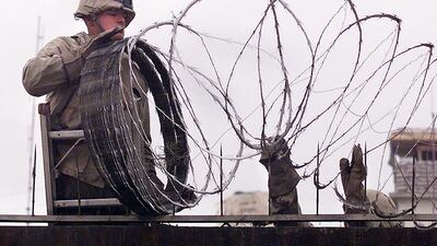 US Marines, seen here placing barbed wire around the US embassy in Kabul on January 11, 2002, are returning to Afghanistan's capital to help embassy workers and Afghans leave the country. AFP