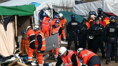 Workers and police officers clear part of the 'jungle' migrant camp on February 29, 2016 in Calais, France after volunteers and aid workers spent months trying to improve conditions in the grim camp. Carl Court/Getty Images