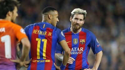 Barcelona’s Lionel Messi, right, smiles while talking with teammate Neymar. Francisco Seco / AP Photo