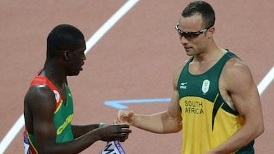 Oscar Pistorius swaps nametags with Grenada's Kirani James following the 400m semi-final at London 2012