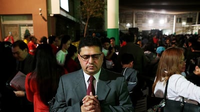 A man prays during Christmas Eve mass at St Joseph’s Cathedral in Abu Dhabi. Christopher Pike / The National