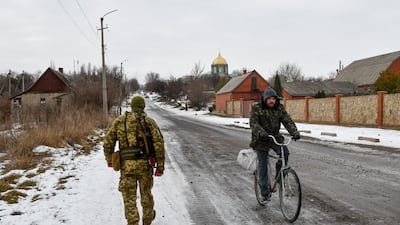 A Ukrainian soldier patrols a street near a frontline with Russia-backed separatists in Yasynuvata district, Donetsk region, eastern Ukraine. AP