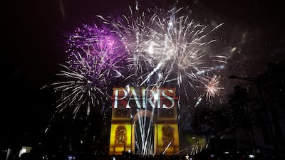 Fireworks explode as the Arc de Triomphe is illuminated during the New Year's celebrations on the Champs Elysees avenue in Paris, France. Reuters