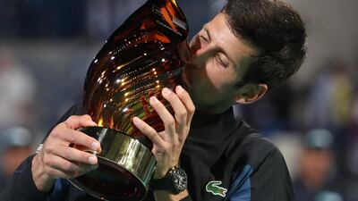 Novak Djokovic celebrates lifting the Mubadala World Tennis Championship trophy for the fourth time in his career. Djokovic beats Kevin Anderson, the defending champion, 6-4, 7-5, 7-5 in Abu Dhabi on Saturday night. Suhaib Salem / Reuters