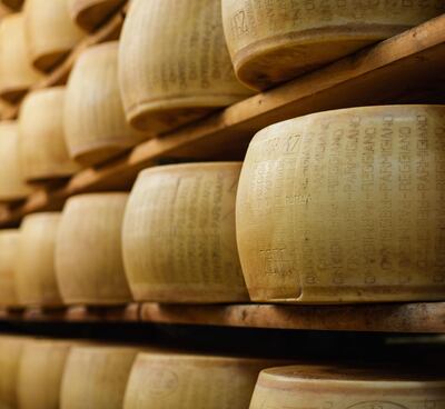 Rounds of parmesan cheese ageing on racks in Modena. Courtesy Getty