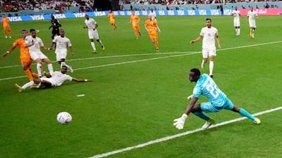 Netherlands' Cody Gakpo finishes past Qatar goalkeeper Meshaal Barsham. Getty