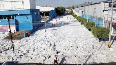 People walk as hail covers the streets in Guadalajara, Mexico. EPA