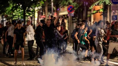 Protestors flee from an exploding firework on a street in Nice, during the fifth night of rioting on July 2. AFP