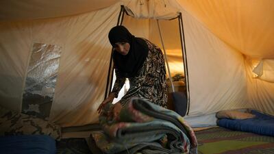 A displaced Iraqi woman packs her belongings as she prepares to be evacuated from the Hammam Al Alil camp south of Mosul in Nineveh province. Reuters