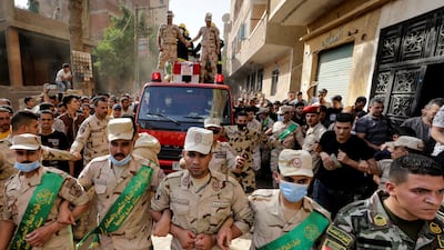 Mourners and soldiers accompany the coffin containing the body of Egyptian officer Soleman Ali Soleman, who was killed in an armed attack in Sinai claimed by ISIS on May 7. Reuters