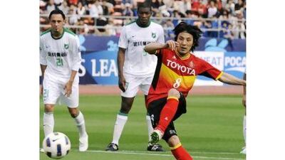 Jungo Fujimoto, the Nagoya Grampus midfielder, scores from the penalty spot against China's Hangzhou Greentown.
