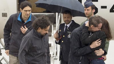 The three freed Spanish journalists Antonio Pampliega, right, Jose Manuel Lopez, left, and Angel Sastre, arrive at the Torrejon military airbase in Madrid, Spain on May 8, 2016. The journalists who went missing while working in Syria in July were freed from captivity and have returned home. Handout photo made available by Presidencia del Gobierno / Moncloa via AP