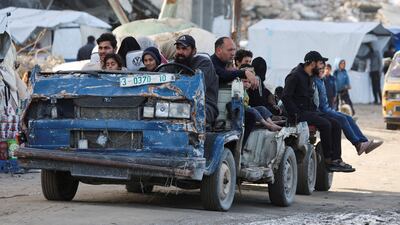 Hussein Liwa, a displaced Palestinian, drives his war-damaged vehicle as he transports residents, in Gaza city. Reuters