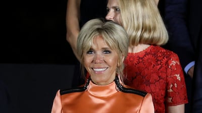 Brigitte, wearing an orange satin Louis Vuitton dress, visits Japan on June 28, 2019. AFP