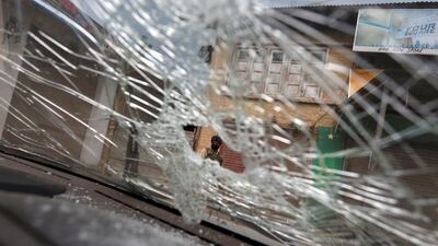 An Indian security force personnel is seen through the broken windshield of a vehicle in Boateng village in south Kashmir's Anantnag district, at the site of a gun battle between Indian police and militants, where seven Hindu pilgrims were killed. Reuters / Danish Ismail
