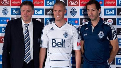 Former Wolves and Cardiff striker Kenny Miller is unveiled to the media at new club Vancouver Whitecaps, flanked by team president Bob Lenarduzzi (l) and head coach Martin Rennie (r)