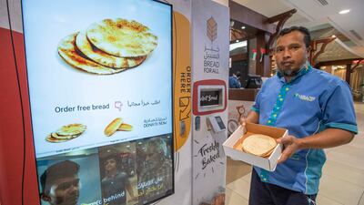 Suhag Mia, a housekeeper from Bangladesh, with his free bread.