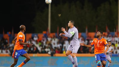 Nassr's Portuguese forward Cristiano Ronaldo (C) heads the ball during the Saudi Pro League football match between Al-Fayha and Al-Nassr at the al-Majmaah stadium in the city of al-Majmaah on April 9, 2023. (Photo by Abdulaziz ALNOMAN / AFP)