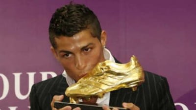 The Manchester United winger Cristiano Ronaldo kisses the Golden Boot trophy after being crowned Europe's most prolific marksman last season.