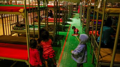 Asylum-seeking migrant girls from Central America, who were expelled from the U.S. and sent back to Mexico with their families under Title 42, play near bunk beds inside the "Kiki Romero" temporary migrant shelter, in Ciudad Juarez, Mexico April 20. Reuters