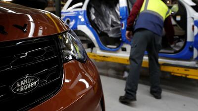 FILE PHOTO: A worker looks inside a vehicle destined for China at the Jaguar Land Rover facility in Solihull, Britain, January 30, 2017. REUTERS/Darren Staples/File Photo