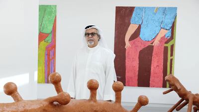 Mohammed Ahmed Ibrahim pictured with his works at the opening of his retrospective exhibition at Sharjah Art Foundation in March 2018. Pawan Singh / The National