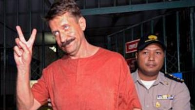 Viktor Bout shows a victory sign after his verdict at the criminal court in Bangkok.