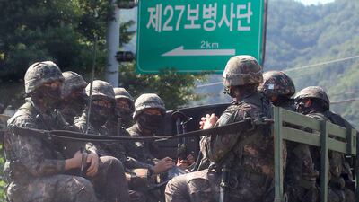 South Korean soldiers ride on a military truck in the border county of Hwacheon on September 4, 2017. The South Korean military said on September 4, it conducted a ballistic missile exercise of a simulated attack on the North's nuclear test site, in response to Pyongyang's sixth nuclear test a day earlier. / AFP PHOTO / YONHAP / STR / - South Korea OUT / NO ARCHIVES - RESTRICTED TO SUBSCRIPTION USE