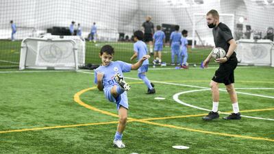 Built on the philosophy and training programme of the Manchester City Academy, City Football Schools offers boys and girls an opportunity to improve their football skills. Khushnum Bhandari / The National