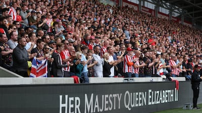 Fans at Brentford's Gtech Community Stadium applaud in a tribute to Her Majesty Queen Elizabeth II, who died at Balmoral Castle on September 8, 2022. Getty