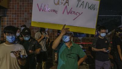 Supporters outside Songshan Airport welcome Ms Pelosi. Bloomberg