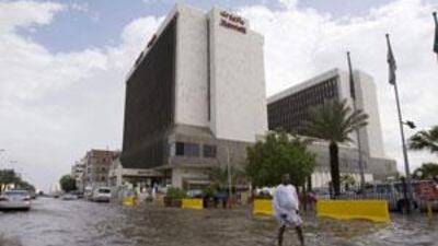 A man walks through a flooded street after a storm produced heavy rain in Jeddah.