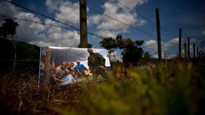A printed photograph taken on October 7, 2017 sits at the same spot where Puerto Rican National Guards delivered food and water to desperate residents. For two months, stranded residents came to this spot for supplies.