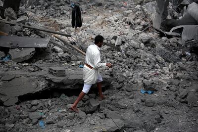 A man inspects the damage around a building after US airstrikes in Sanaa. EPA