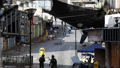 Israeli soldiers take position during clashes with Palestinian stone throwers in the West Bank city of Hebron. EPA