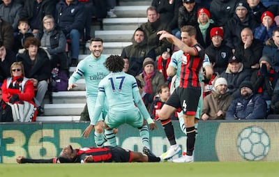 Jefferson Lerma lays dejected on the ground after his spectacular own goal gave Arsenal the lead. Reuters