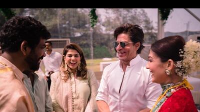 Shah Rukh Khan shares a light moment with the bride and groom.