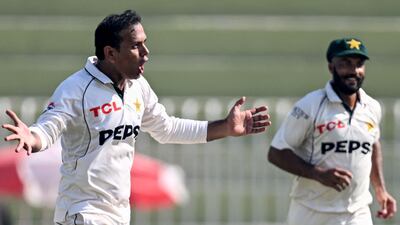 Pakistan's Noman Ali, left, celebrates after taking the wicket of England's captain Ben Stokes. AFP