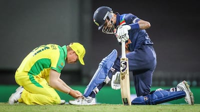 Australia’s David Warner ties the shoelace for India’s Hardik Pandya. AFP