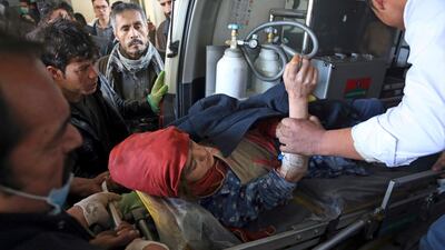 People carry an injured woman to hospital. Rahmat Gul / AP Photo