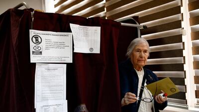 A voter leaves a booth with ballot papers at a polling station at a primary school in Ankara, Turkey, on June 24, 2018. Burhan Ozbilici / AP Photo