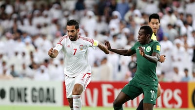 UAE striker Ali Mabkhout runs past Saudi Arabia's Abdulmalek Al Khaibri during their World Cup qualifier against Saudi Arabia at Hazza bin Zayed Stadium on Tuesday. Chris Whiteoak / The National