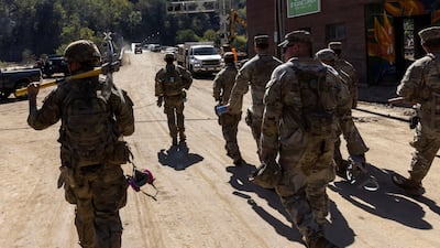 Soldiers arrive to help residents remove debris and mud from their homes after Hurricane Helene in Marshall, North Carolina. Reuters