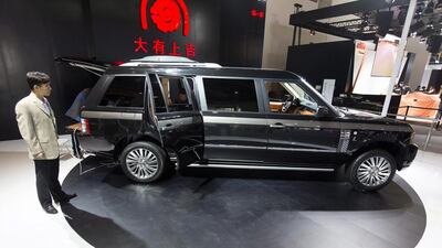 A custom stretched Range Rover SUV is readied for display during Auto China 2014 in Beijing, on April 20. Adrian Bradshaw / EPA