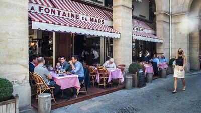 People relax on the terrace of the 'La Fontaine de Mars' restaurant in Paris. EPA