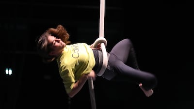 A rope artist training backstage